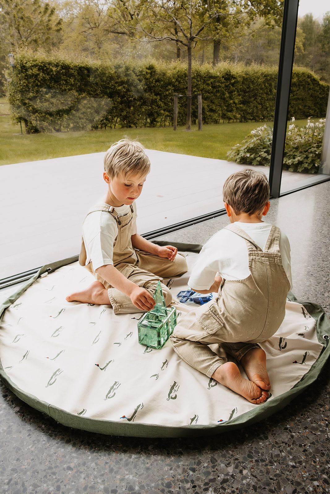 croco toy storage bag and playmat, children are playing on the mat