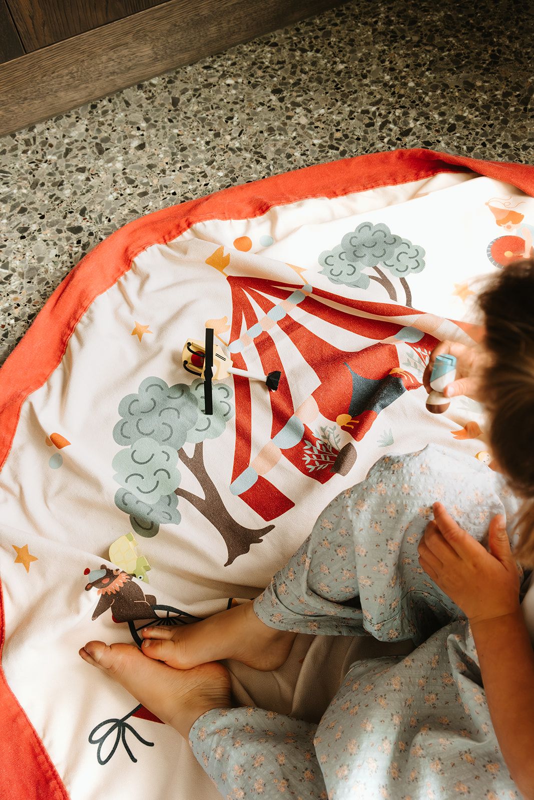 circus toy storage bag and playmat, child is playing in the mat