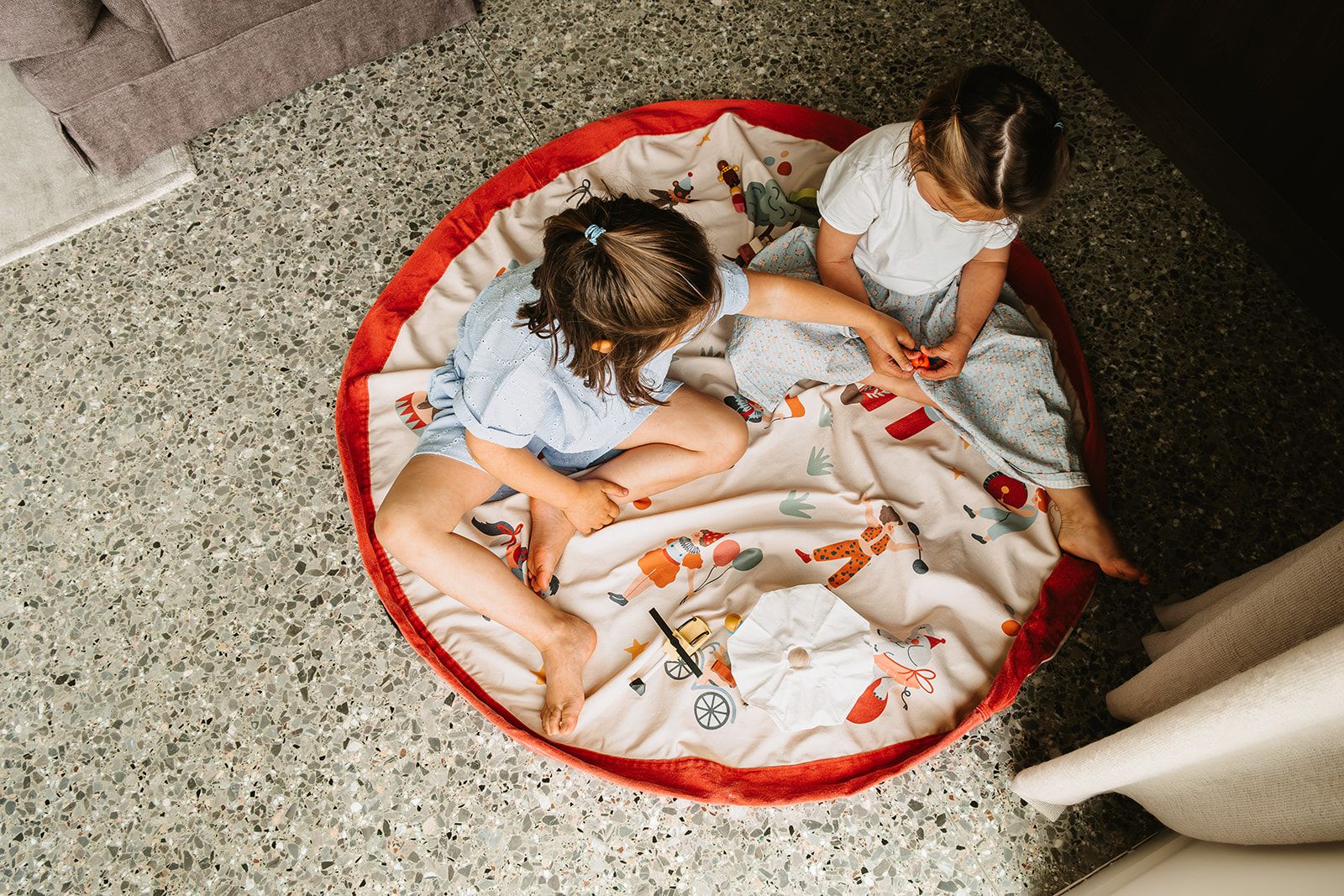 circus toy storage bag and playmat, children sititng on the mat while playing