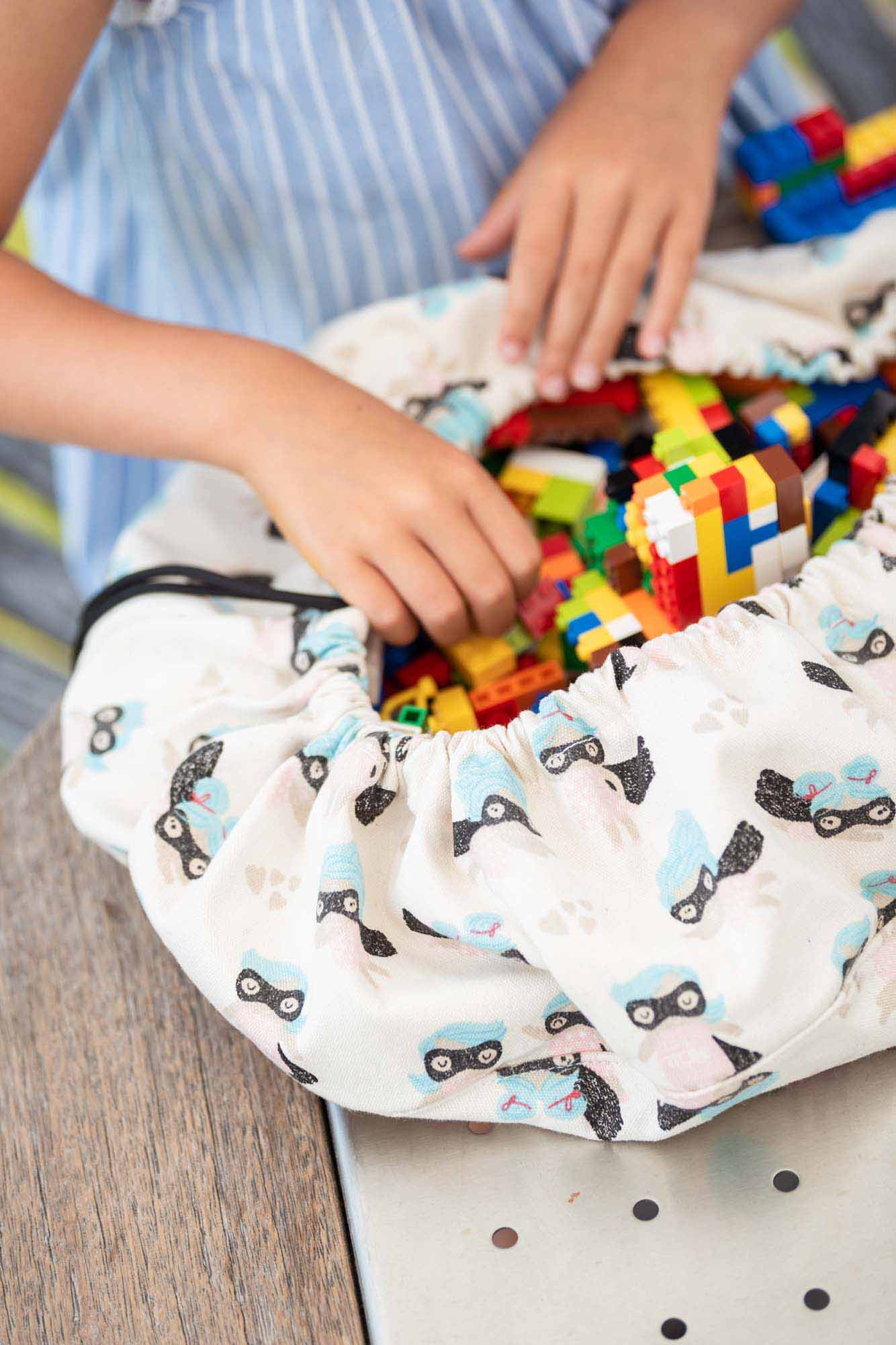supergirl mini toy storage bag, filled with lego
