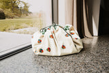 snails toy storage bag and playmat, closed back in front of the window