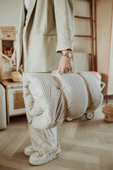 bloom stripes blue babymat, person is carrying the bag while leaving the house