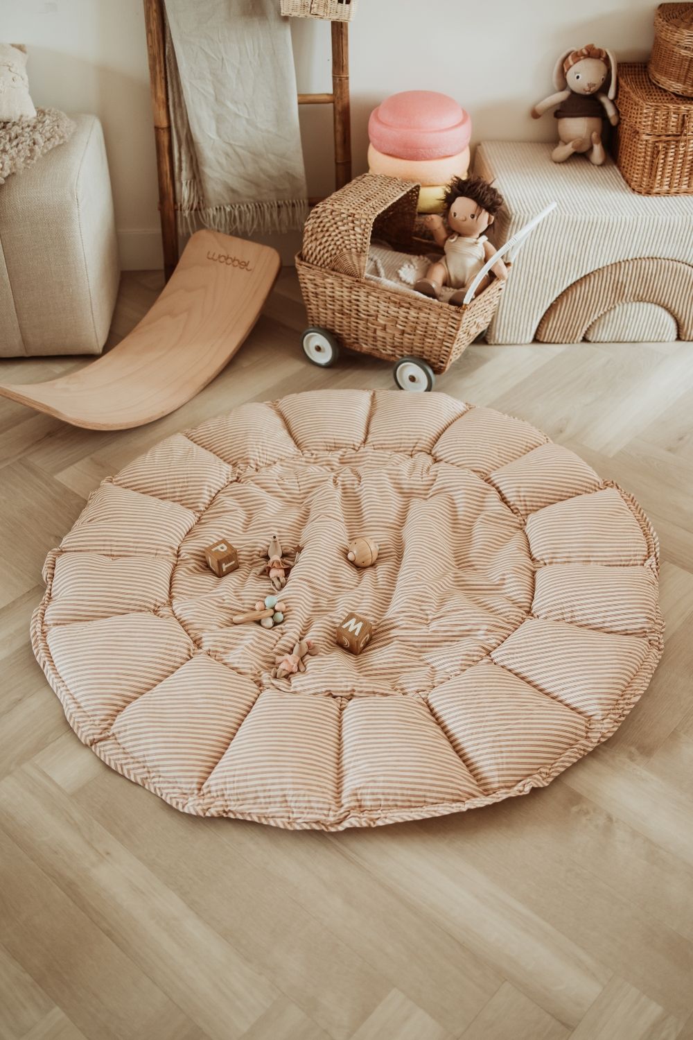 bloom stripes brown babymat, open on floor in kidsroom, wooden toys, a slide, toddler, dolls