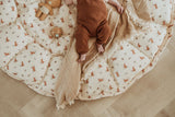 bloom rabbit babymat, open on floor, baby is lying on a blanket on the babymat
