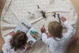 cherry cherry toy storage bag, open on floor, children playing and reading a book