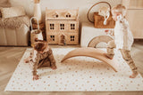EEVAA treehouse puzzlemat, kidsroom, backside with stars print, a child is sitting on the mat while the other one is walking over a swing board