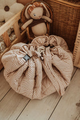 soft stripes brown organic babymat, closed bag on the floor in kidsroom