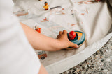 citymap toy storage bag and playmat, child is playing with wooden toys