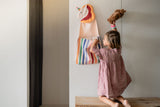 toto unicorn, hanging on the wall, child is putting its cuddle bear in the bag