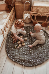 birds soft organic babymat, children are sitting on the open mat while playing with wooden blocks