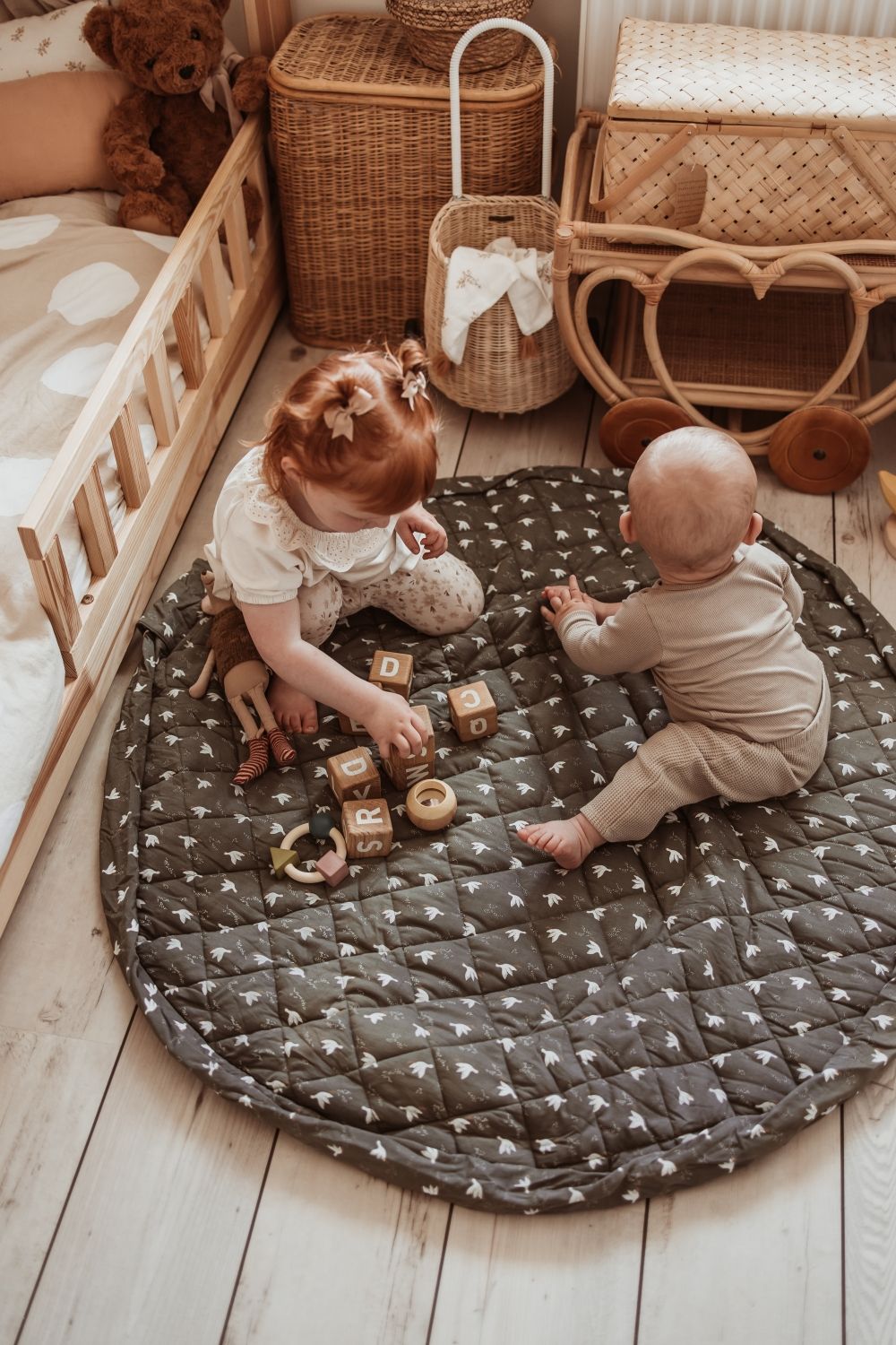 birds soft organic babymat, children are sitting on the open mat while playing with wooden blocks
