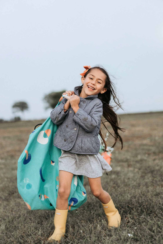 outdoor play toy storage bag, girl carrying the bag