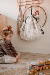 jungle toystorage bag, hanging on coat rack, child playing on floor