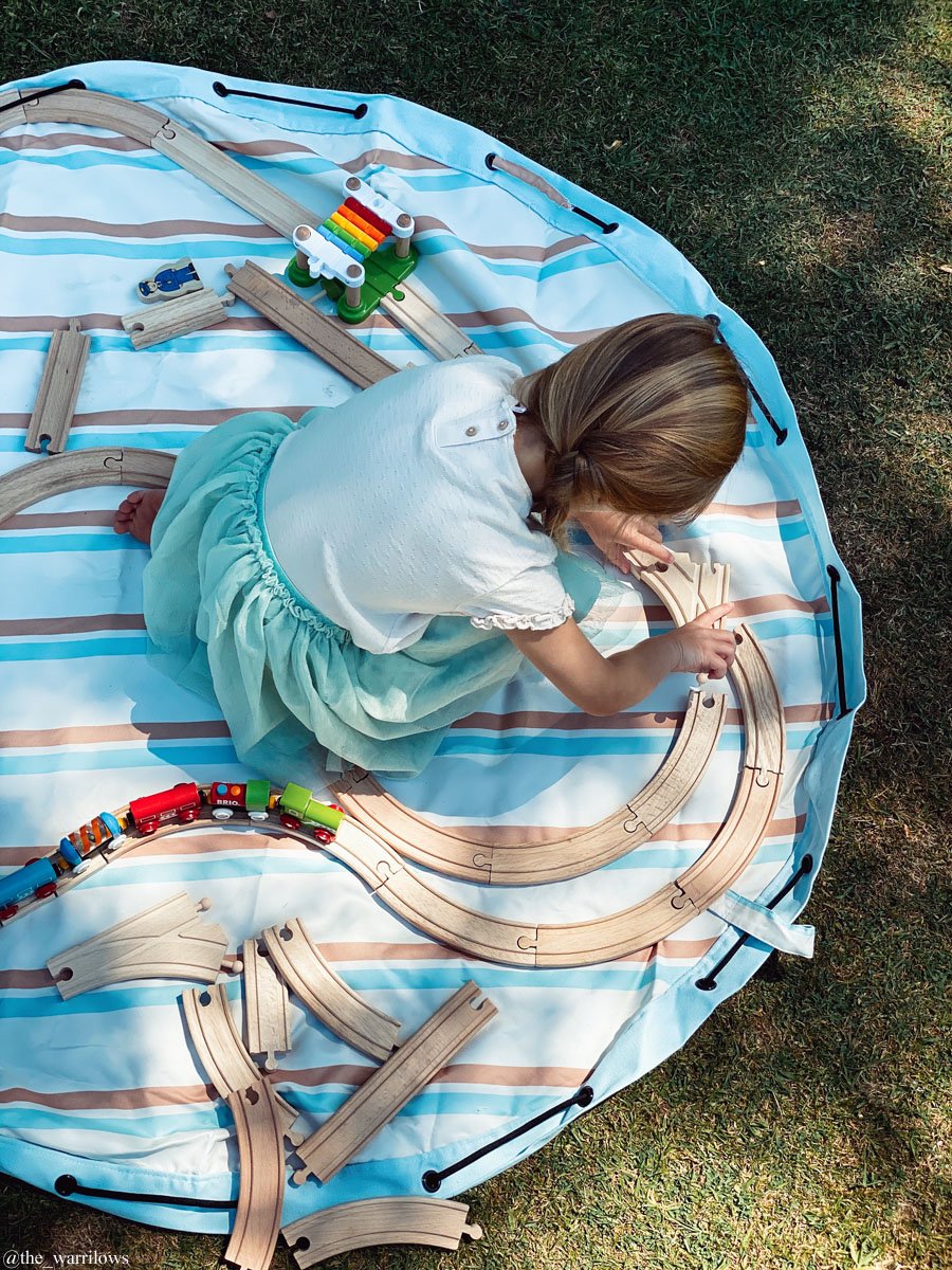 Play&Go outdoor storage bag and play mat, girl playing with wooden toyx, trainrail