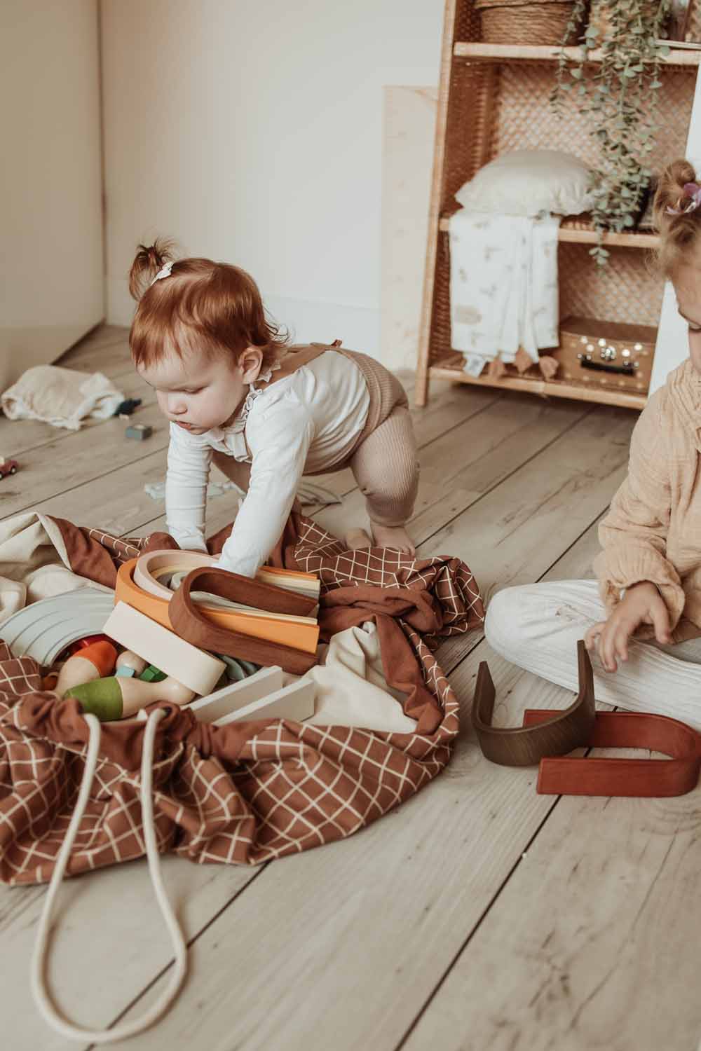organic grid brown storage bag, filled with toys, children playing in kidsroom
