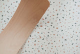 detail picture of terrazzo puzzlemat, wooden slide on top of the mat