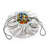 jungle storage bag, detail picture of closed bag, filled with lego